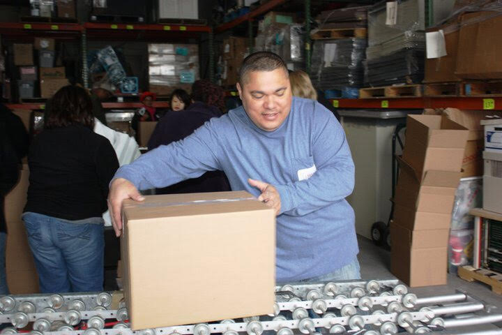 Jimmy Badillo packing a Box of Love®.