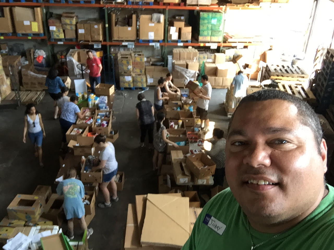 Jimmy Badillo with others packing Boxes of Love®.