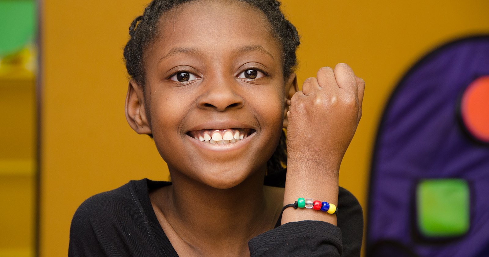 Young girls shoes off her gospel bead bracelet