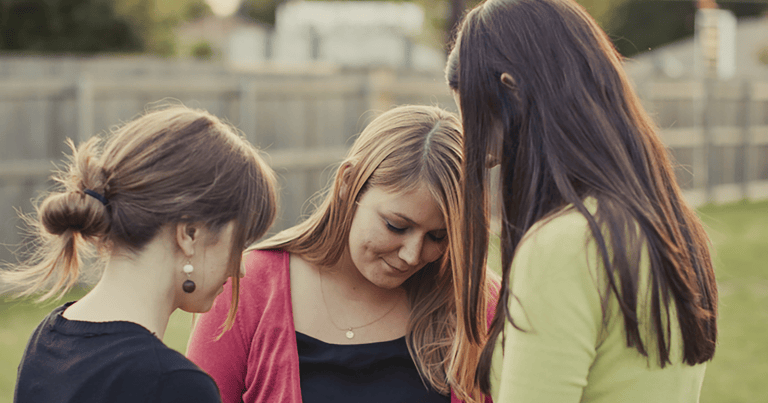Three women praying